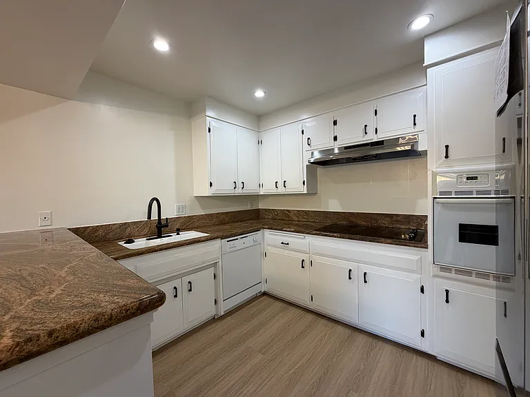Kitchen with Granite Counter, Smooth Cooktop, & Large Stainless Steel Fridge