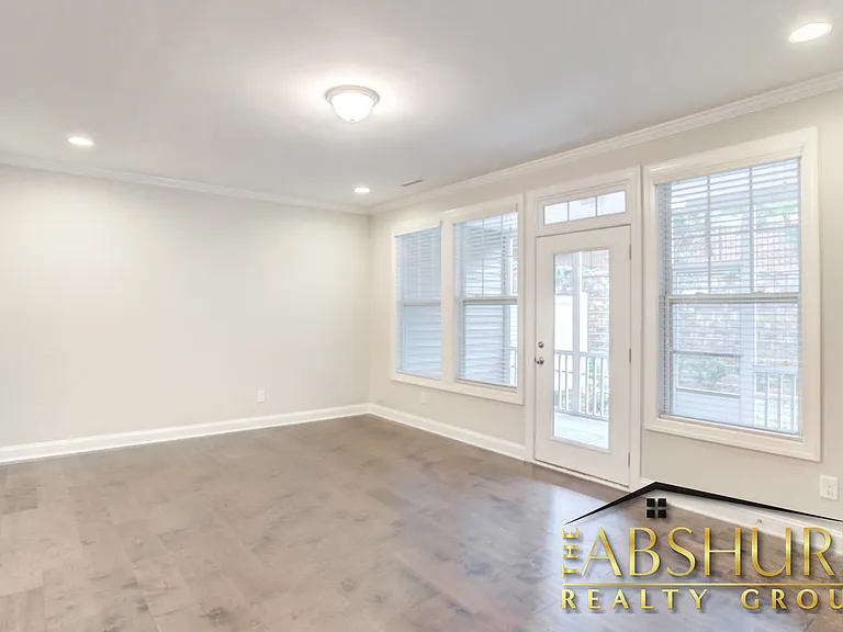 Open concept living room with crown molding, gas fireplace and energy efficient recessed lighting