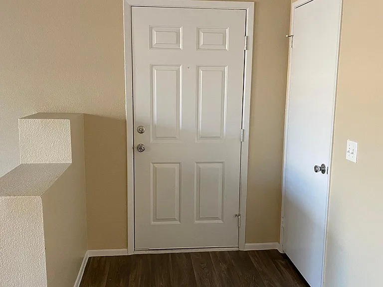 downstairs 2 bedroom - view of front door from inside the apartment - coat closet to right of front door
