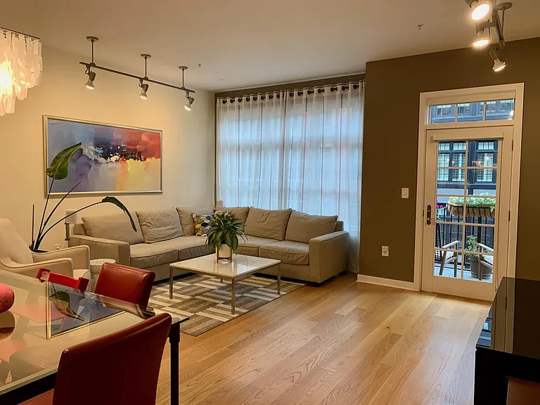 Living/Dining Room with Large Windows Overlooking Courtyard