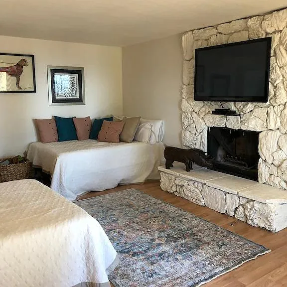 Two full beds and a mounted TV with cable.