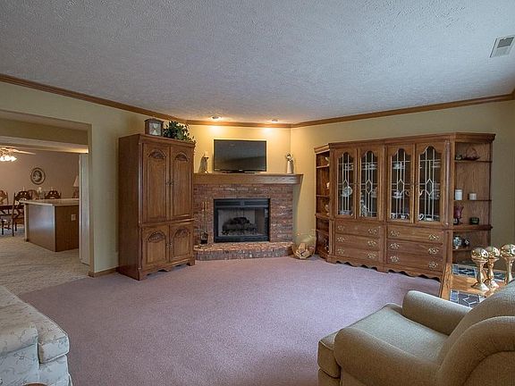 Front living room view with gas fireplace. * Television is sitting on mantel, not attached to wall.