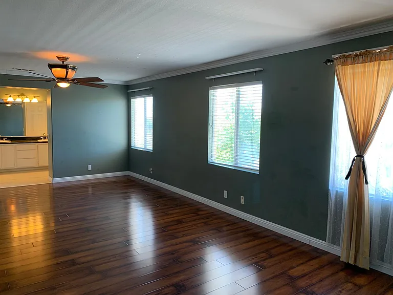 Very large master bedroom with many windows.