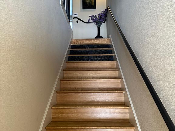The stairway leading to the second floor where the kitchen, living room, dining room and balcony overlooking Santana Row are located