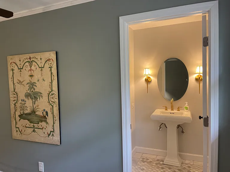 En-suite bathroom with marble shower and banded marble floors.