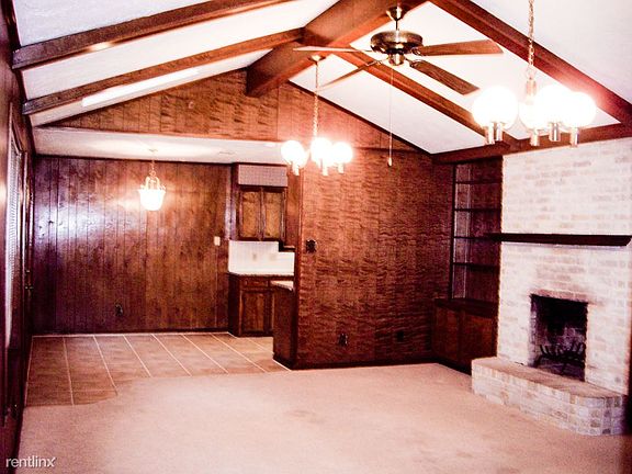 Living w vaulted ceiling, beige carpet in this room
