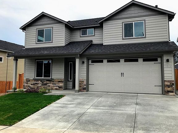 Front of home with extra-large driveway and welcoming front porch!