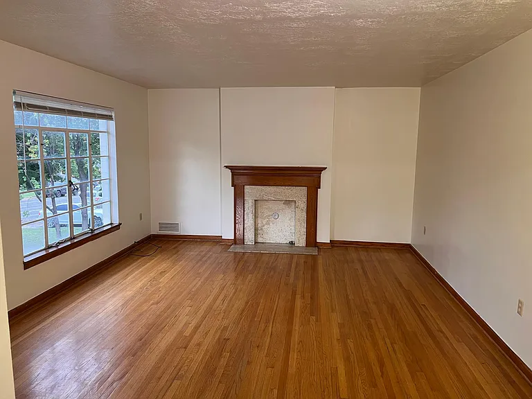 Spacious living area, original hardwood floors and large windows throughout.