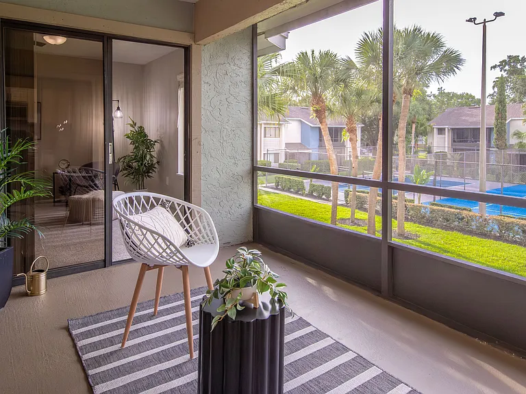 Get some fresh air from your private screened-in patio overlooking lush landscaping.