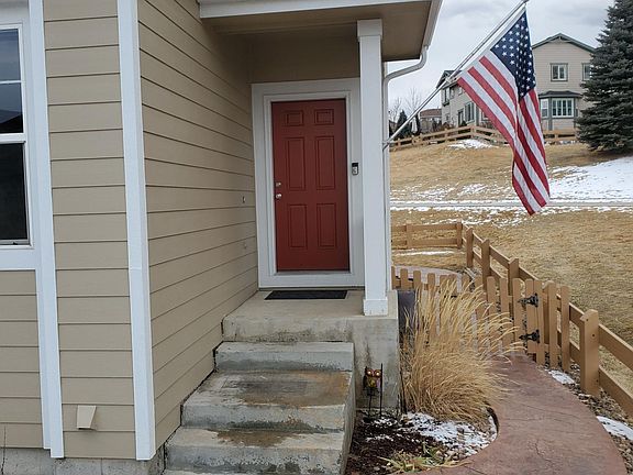 Entry with Ring doorbell and stamped concrete path to fenced backyard.