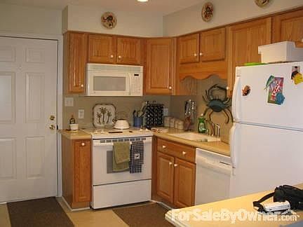 Kitchen with panty & stacked laundry : Renovated w/ new cabinets, solid surface countertops & applia