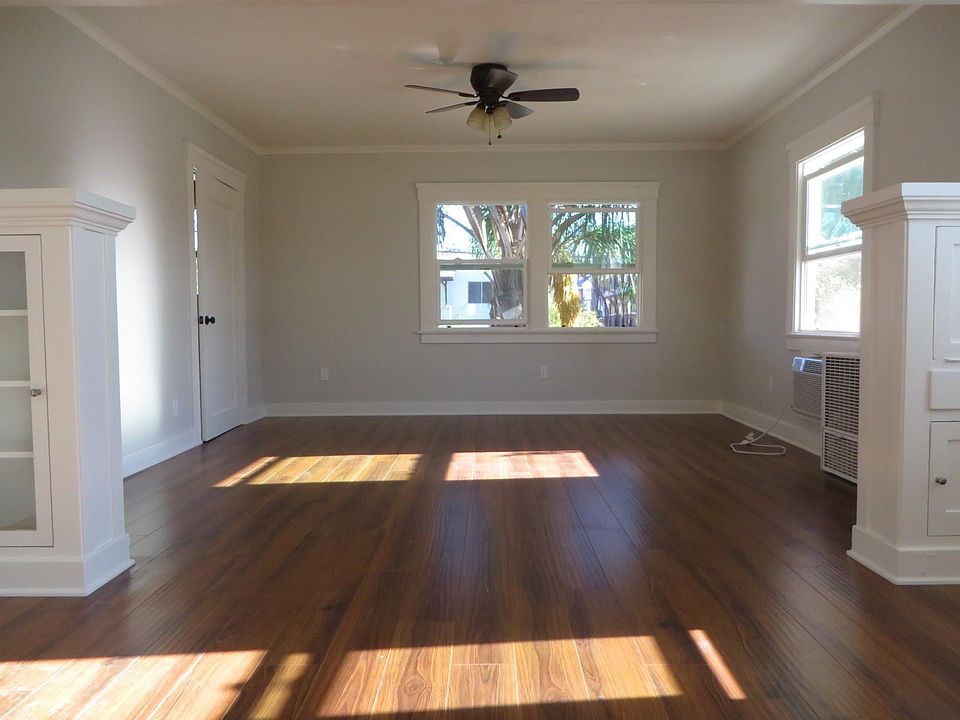 Dining room with built ins and living room that leads to closet/office.