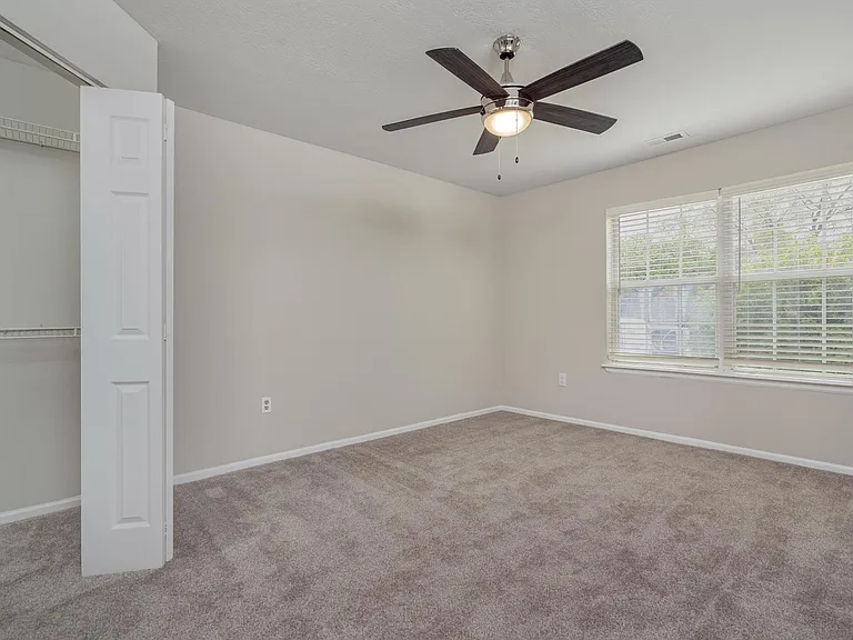 The Glenmount primary bedroom with plush carpeting