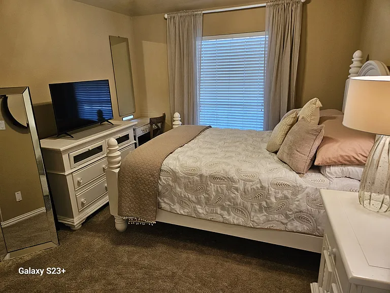 3rd Bedroom with Queen bed, dresser, vanity desk, included TV, and brand-new pillows and bed linens.