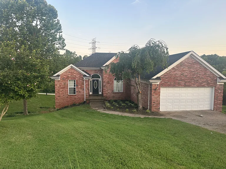 Front elevation with updated landscape. Will be mulched soon. All new black gutters with new updated outside black lantern light fixtures.