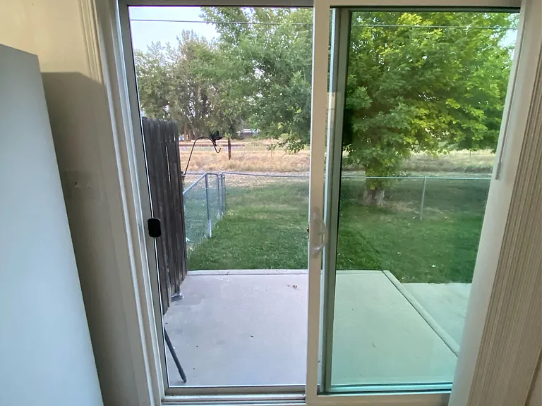 Kitchen Sliding glass door to large fenced yard