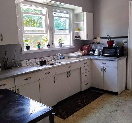 Kitchen with new windows and lots of storage.