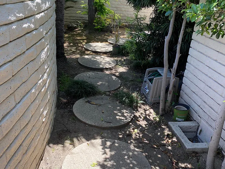 Outdoor pathway leading to back yard.