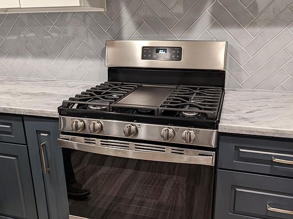 New gas range and hood in newly remodeled kitchen
