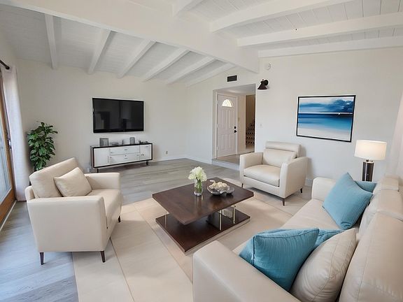 Spacious living room (15' x 18') features a large Andersen sliding door to a bright balcony
