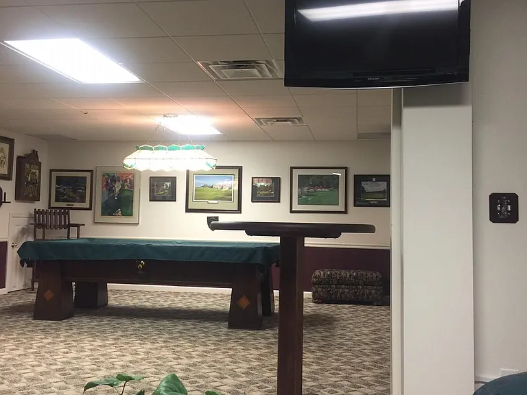 View from lounging area across High Top Bar Table with 100 year old Antique Brunswick Pool Table in background - lower entertainment level