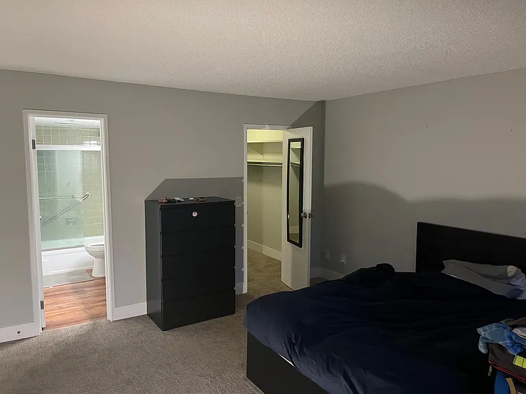 main bedroom looking into attached full bath and closet