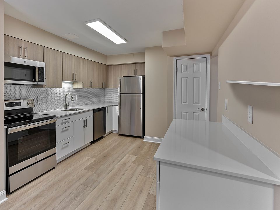 This beautifully updated kitchen, shown at our sister community Woods Edge, highlights the same sleek finishes coming soon to North Crossing Apartments _ including stainless steel appliances, quartz countertops, and designer cabinetry.