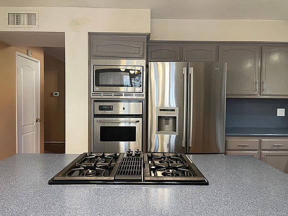 Kitchen appliances. The cooktop on the island adds fun to the cooking.