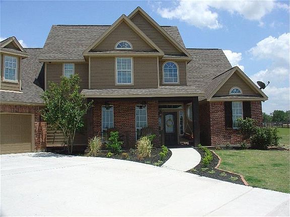 Tastefully landscaped with a charming entrance.