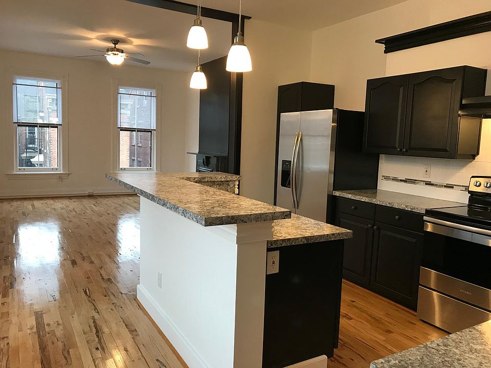 Open concept; the kitchen opens to the living room. Lots of space! There is a 3rd floor above these two rooms (same square footage) with plenty of room for storage.
