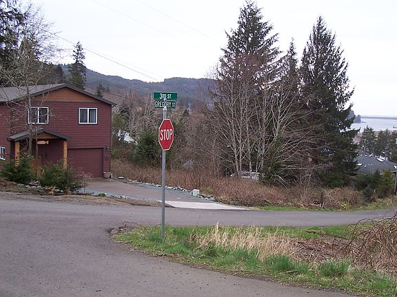 Lot is to right of red house