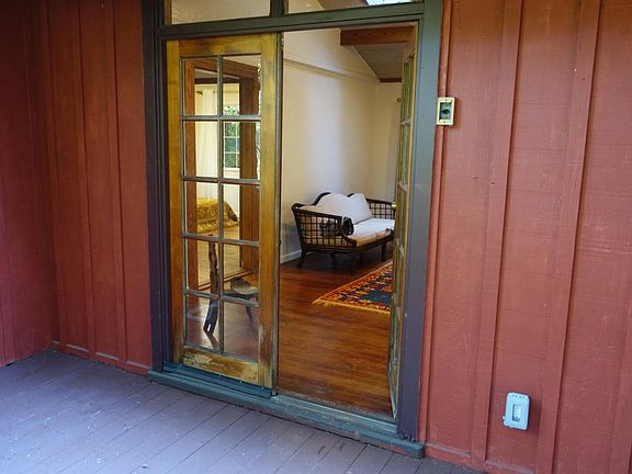 A large wooden sundeck leads off the living room