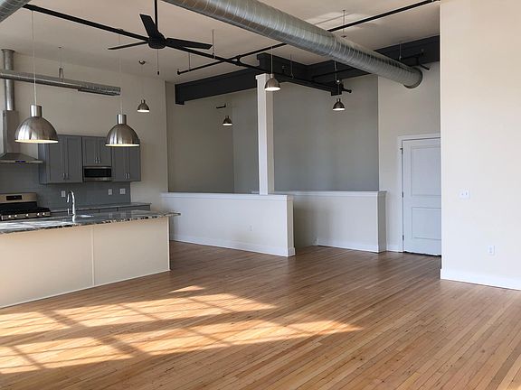 2nd floor living space features half bath and restored hardwood floors.