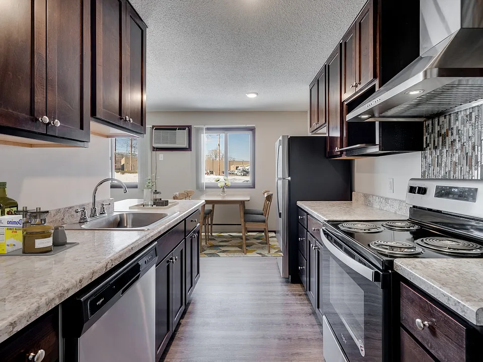 Elevate your living at St. Anthony Group with this modern kitchen featuring sleek cabinetry and stainless steel appliances. Enjoy spacious layouts and convenient amenities ideal for your lifestyle. Schedule your tour today and see for yourself!
