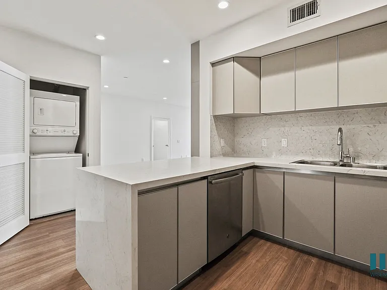 Kitchen with Countertop Bar and In-Suite Washer & Dryer