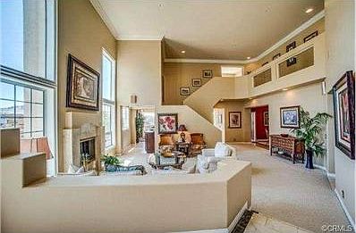 Double Door Entrance to an open 2-story Living Room with Picture