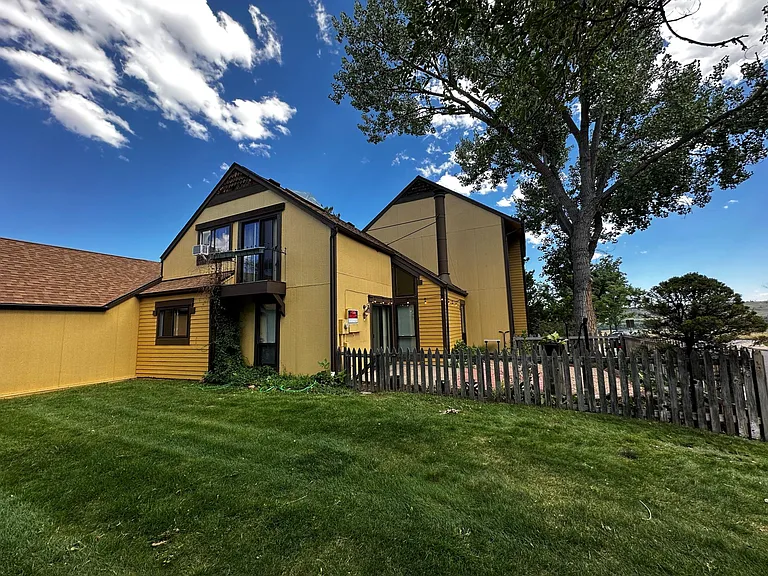 NW side of home with patio and fenced xeriscaped yard