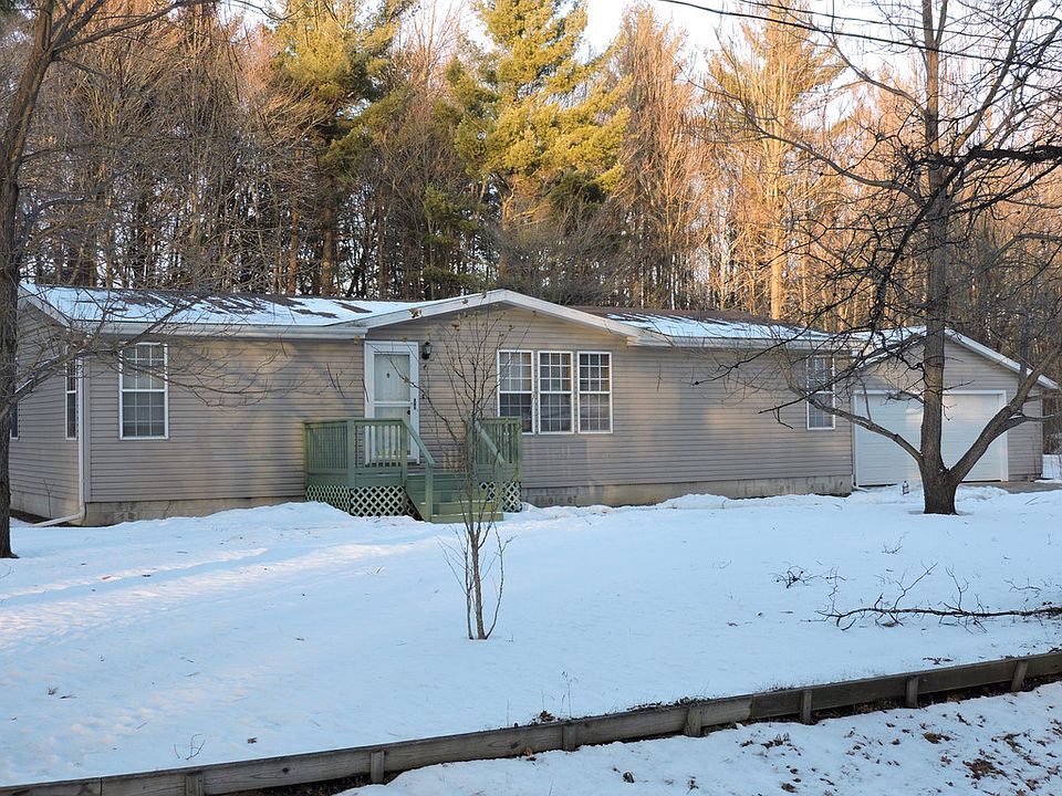 SOMETHING SENSATIONAL!  The unexpected extras are what make this home sensational.  Most notably, the 2x6 constructed home sits on a full basement to add an additional 1378 square feet of space to finish if needed.  As well, the home is drywalled throughout (no wallboard found in this quality manufactured home!) with newer carpet in the living room, and bedrooms, and ceramic tile in the kitchen and dining room.  Located on 2 treed acres with city water and close to US 10, this sensational home also has an oversized heated garage, with overhead storage and workbenches.  3 bedrooms and 2 full bathrooms are nicely done and waiting to wow you!