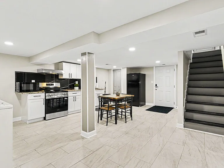 Updated kitchen with stainless-steel range, ample cabinetry, and adjacent dining nook for everyday meals.
