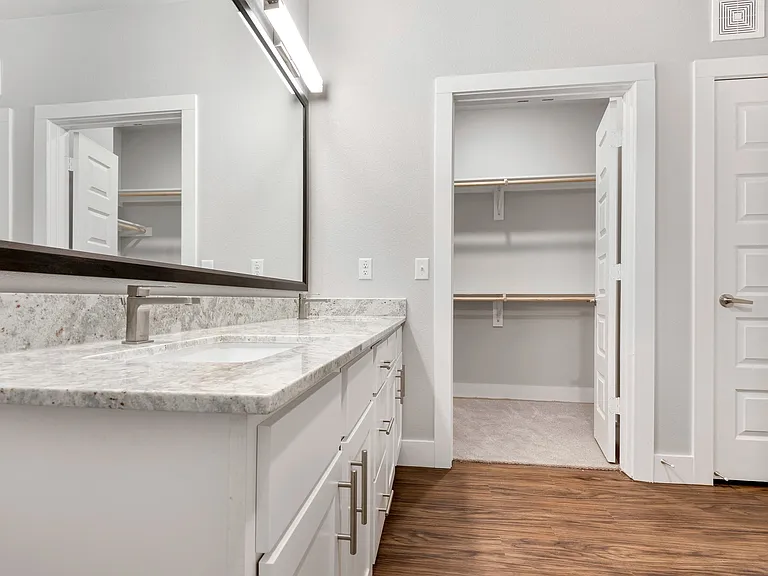 Large mirror vanities and plentiful storage in bathrooms.