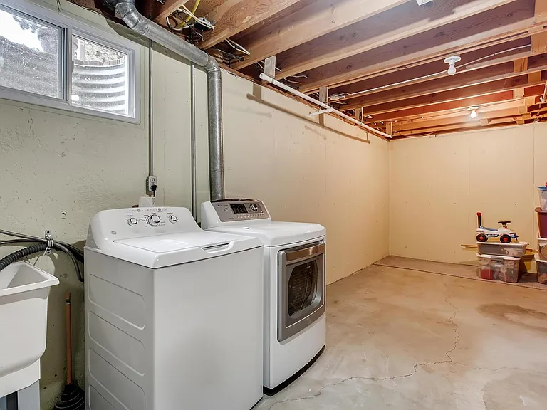 Utility room with new washer, dryer, added storage