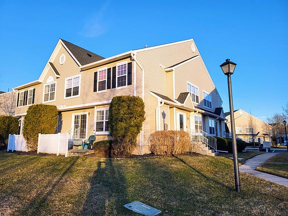 End unit with extended patio facing private natural view