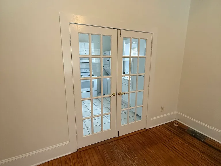 Closed French door between living room and kitchen.