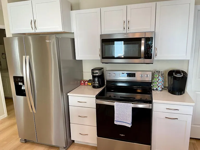 Coffee makers, refrigerator, oven, and microwave.