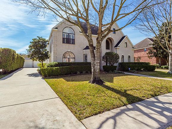 Large front yard, mature trees, and 3-car garage.