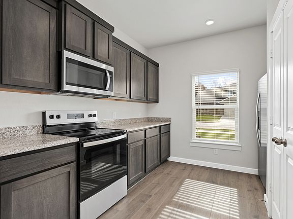 The kitchen has beautiful wood cabinetry.