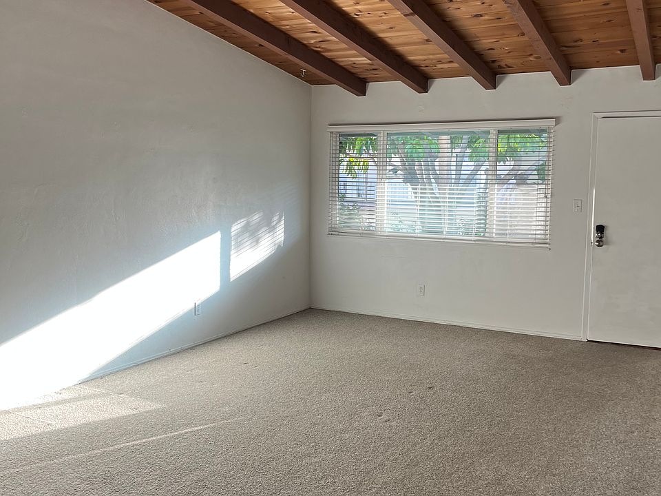 large living room with vaulted wood beam ceiling