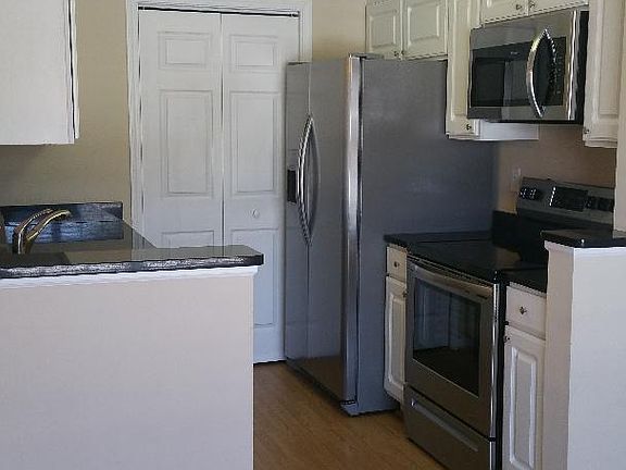 Kitchen with upgraded appliances. Includes dishwasher, microwave and disposal. New cabinets and granite counter tops.