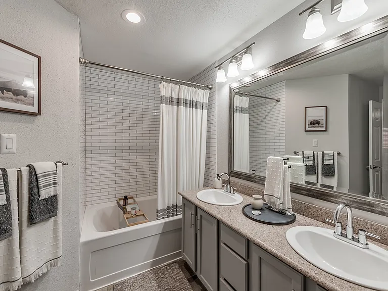 Upscale bathroom with soaking tub and framed vanity