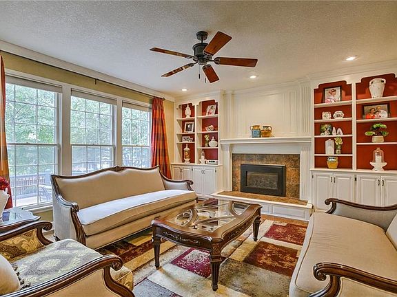 Family room with fireplace flanked by built-in cabinets